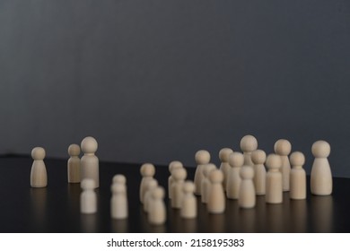 wooden mannequin on wooden floor arranged in groups at the meeting Leadership concept wooden puppet man on black table gray background - Powered by Shutterstock