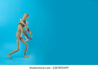 Wooden mannequin parent hugging their child in a blue background - Powered by Shutterstock