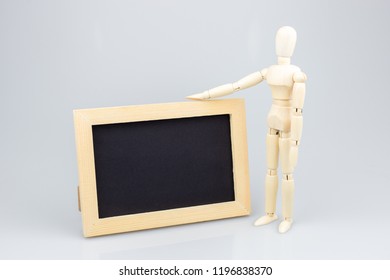 Wooden Mannequin With Photo Fram On White Background.