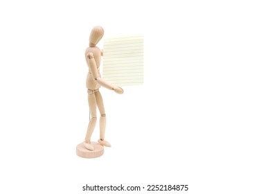 Wooden mannequin with sheets of paper concept, blank space. Wooden doll and a blank piece of paper. Creativity and art. Copyspace - Powered by Shutterstock