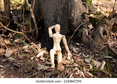 Wooden mannequin sit in front of the tree body, wood puppet take a nap on the forest, front view, relaxing and chilling, autumn concept forest background - Powered by Shutterstock