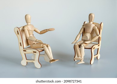 wooden mannequins on psychological therapy sitting in armchairs - Powered by Shutterstock