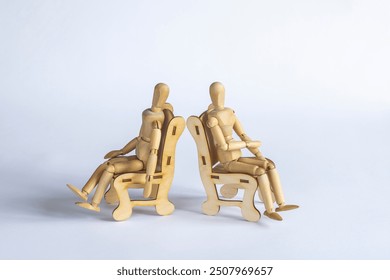 wooden mannequins on psychological therapy sitting in armchairs and refusing to agree - Powered by Shutterstock