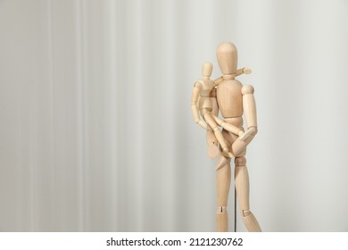 Wooden Mannequins Of Parent With Child On Light Background, Space For Text. Family Day