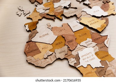 Wooden map of the world on a light background. Self made. Plywood. In beige tones. Europe, Africa and the Middle East, Gulf countries. Western Europe.