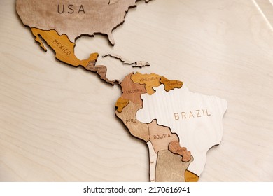 Wooden map of the world on a light background. Self made. Plywood. In beige tones. Central and South America. Geography of Latin America. Mexico, Brazil, Cuba, Venezuela, Bolivia. - Shutterstock ID 2170616941