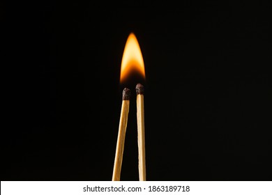 Wooden matches with fire on a black background