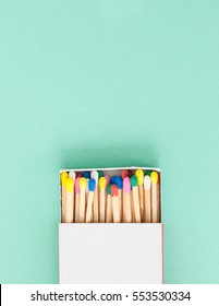 Wooden matches in pastel colors on blue