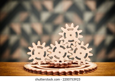 Wooden Mechanical Puzzle And Gears On The Table. Toy And Game Parts And Symbols