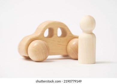 The Wooden Miniature Car And  The Wooden Doll In White Background