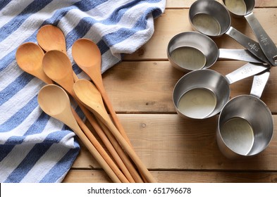 Wooden Mixing Spoons And Blue Dish Towel