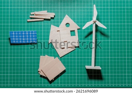 Wooden model making tools and components for renewable energy projects displayed on a green cutting mat