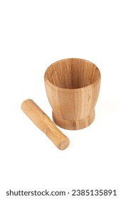 Wooden mortar and wooden pestle for grinding spices, isolated on a white background. Copy space.
