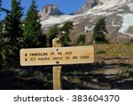 Wooden mountains trail pointer with Mount Hood in the background. Timberline trail and Pacific Crest trail, Oregon, USA Pacific Northwest.