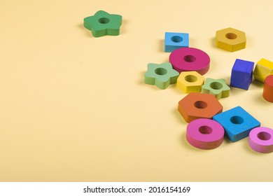 Wooden Multicolored Geometric Shapes For Children On A Solid Background