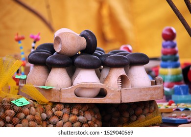 Wooden Mushrooms On Plate With Dark Brown Heads In Local Craft Fair In Valmiera, Latvia. 