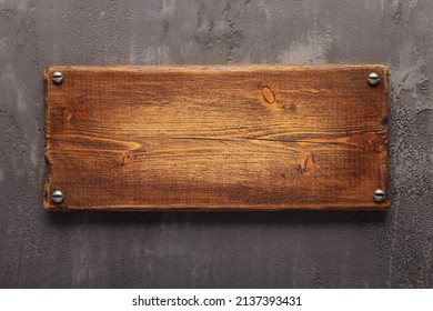 Wooden nameplate or sign board screwed on wall background. Front view of name plate - Shutterstock ID 2137393431