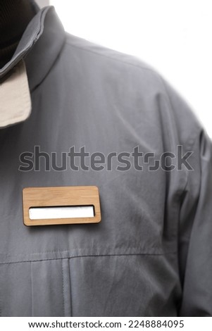 Wooden nametag on person chest