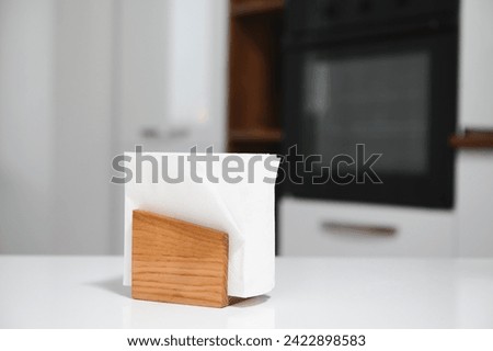 Wooden napkin holder in kitchen.