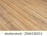 Wooden natural laminate on floor. Laying laminate flooring. Laminate laying scheme