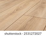 Wooden natural laminate or parquet on floor. Joining the laminate. Wood texture. Soft focus