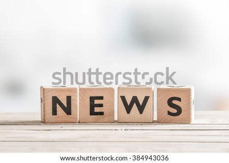 Wooden news sign on a table in an office