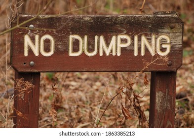 A Wooden No Dumping Sign.