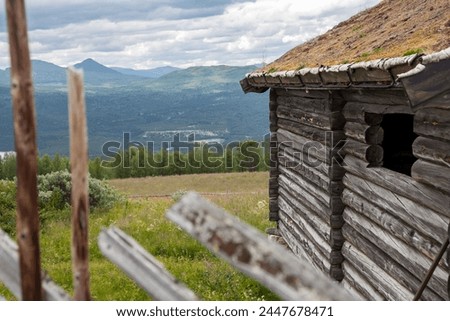 Wooden Norwegian stuga with a beautiful view of a valley with mountains in the background