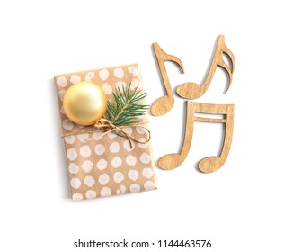 Wooden Notes And Gift Box On White Background. Christmas Music Concept