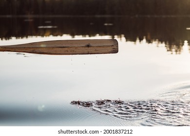 Wooden Oar, Water Drops And Ripples On Calm Lake