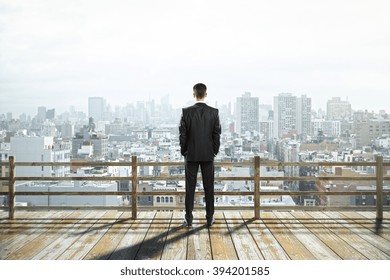 Wooden Observation Platform With Foggy City View And Businessman