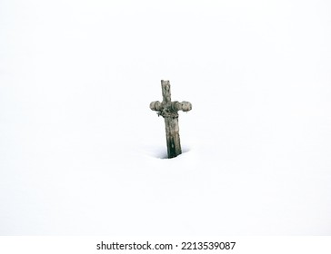 A Wooden Old Cross On A Clear White Snowy Field