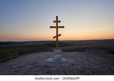 Wooden orthodox cross on the top of Golgotha in the Kostomarovo St. Saviour Monastery at sunset.
