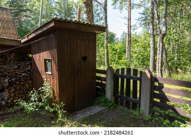 Wooden Outhouse In A Yard Of A Houese