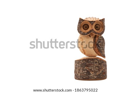 Wooden owl (Strigiformes) carved from wood, handcrafted. copy space. isolated on white. Front view.
