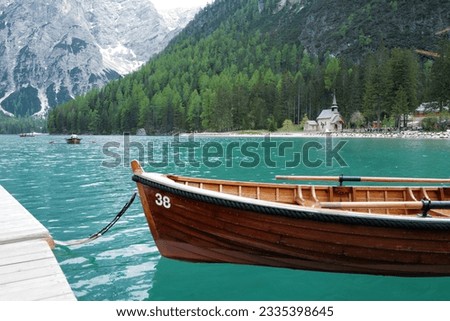 A wooden paddle boat among natural landscape view of Lake Lago di Braies with Dolomiti (Dolomites) snowy mountain range- South Tyrol, Italy Foto d'archivio © 