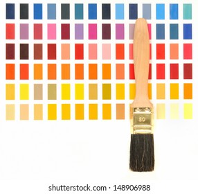 Wooden Paint Brush In Front Of A Color Chart