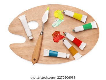 Wooden palette with oil paints and palette knife on white background, top view