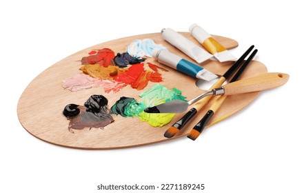 Wooden palette with oil paints and tools on white background - Powered by Shutterstock