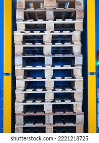 Wooden pallets are stacked on top of each other. Old pallets inside blue rack. Several europallets are stacked. Old pallets for transportation and storage. Europallets for manufacturing company - Shutterstock ID 2221218725