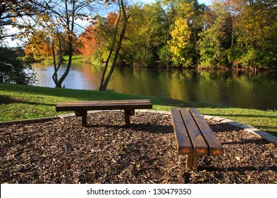 Wooden Park Benches Overlooking A Fishing Lake In Autumn, Southwestern Ohio, USA
