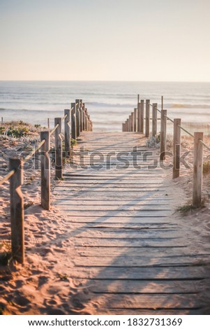 Wooden path on the beach during golden hour in Porto, Portugal