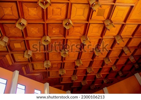 The wooden pattern ceiling is decorated with neon lights