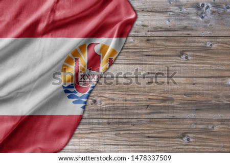 Wooden pattern old nature table board with French Polynesia flag