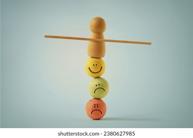 Wooden pawn balancing on beads faces with different mood expressions - Concept of emotional and mental balance