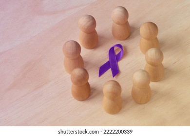 Wooden pawn in a circle around violet ribbon - Concept of Domestic Violence awareness; Alzheimer's disease, Pancreatic cancer, Epilepsy awareness and Hodgkin's Lymphoma - Shutterstock ID 2222200339