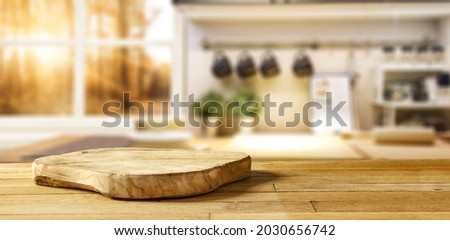 Wooden pedestal on table in kitchen interior and free space for your decoration 