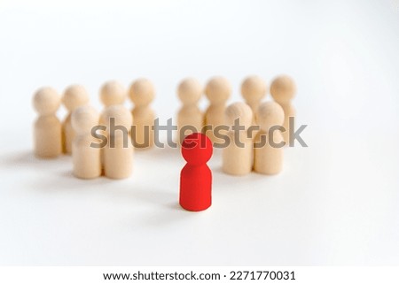 Wooden peg doll, selective focus. Leadership concept. Isolated people from society or groups of people who are in doubt, conflict.