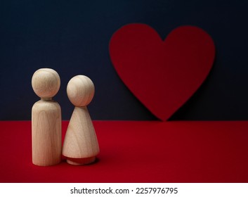 wooden peg dolls couple standing before red heart with navy background. Love, romantic, Valentine's Day, lover, couple, relationship. - Shutterstock ID 2257976795