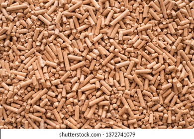 Wooden pellets background, pattern. Close up natural wood pellet. Ecological heating, renewable energy Biofuels. Top view. Flat lay ecological fuel for solid fuel boilers. 